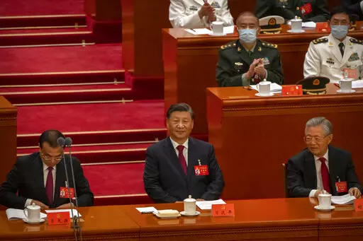 China's President Xi Jinping, center, sits after giving a speech during the opening ceremony of the 20th National Congress of China's ruling Communist Party in Beijing, Sunday, Oct. 16, 2022. The overarching theme emerging from China's ongoing Communist Party congress is one of continuity, not change. The weeklong meeting is expected to reappoint Xi as leader, reaffirm a commitment to his policies for the next five years and possibly elevate his status even further as one of the most powerful le