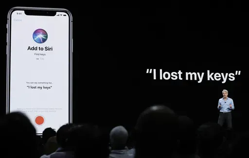 Craig Federighi, Apple's senior vice president of Software Engineering, speaks about Siri during an announcement of new products at the Apple Worldwide Developers Conference in San Jose, Calif., June 4, 2018. (AP Photo/Marcio Jose Sanchez, File)