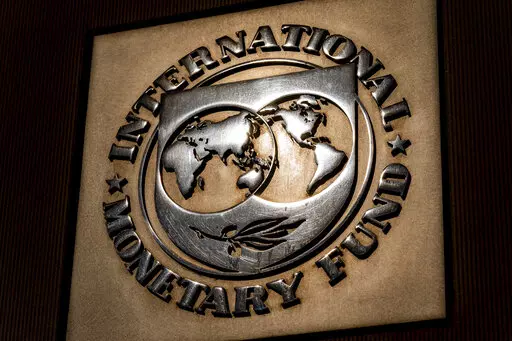 The logo of the International Monetary Fund is visible on their building, April 5, 2021, in Washington. The IMF is facing pressure to eliminate, or at least, reevaluate how it imposes fees on loans it disperses to needy countries like war-torn Ukraine — which is one of the fund's biggest borrowers. (AP Photo/Andrew Harnik)