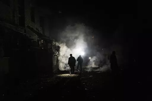 Resident walks amid debris after a Russian attack in Kherson, southern Ukraine, Nov. 24, 2022. In a deliberate, widespread campaign, Russian forces systematically targeted influential Ukrainians, nationally and locally, to neutralize resistance through detention, torture and executions, an Associated Press investigation has found. (AP Photo/Bernat Armangue, File)