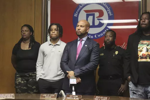 D'Monterrio Gibson, second from left, stands with his attorney Carlos Moore, center, at a press conference before jury selection in Lincoln County Circuit Court, Tuesday, Aug. 15, 2023, in Brookhaven, Miss. Gibson, a FedEx driver, was allegedly shot at by Gregory Case and his son Brandon Case. The Cases were later arrested and indicted by a grand jury for attempted murder, conspiracy of murder and shooting into a moving vehicle. (Hunter Cloud/The Daily Leader via AP)