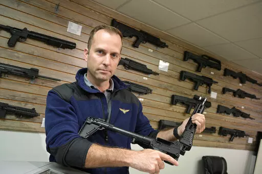Adrian Kellgren, director of industrial production of KelTec, holds a 9mm SUB2000 rifle, similar to ones being shipped to Ukraine, at their manufacturing facility on Thursday, March 17, 2022, in Cocoa, Fla. Kellgren’s family-owned gun company was left holding a $200,000 shipment of semi-automatic rifles after a longtime customer in Odessa suddenly went silent during Vladimir Putin’s invasion of Ukraine. Fearing the worst, the company decided to put those stranded 400 guns to good use, sendin