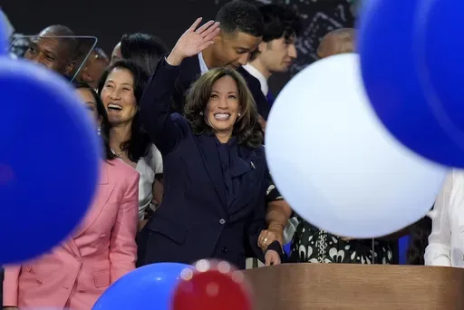 Democratic presidential nominee Vice President Kamala Harris waves surrounded by balloons at the Democratic National Convention Thursday, Aug. 22, 2024, in Chicago. (AP Photo/J. Scott Applewhite)