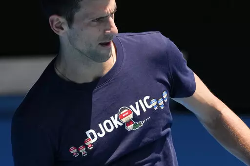 Defending men's champion Serbia's Novak Djokovic practices on Rod Laver Arena ahead of the Australian Open tennis championship in Melbourne, Australia, Wednesday, Jan. 12, 2022.  The drama over Djokovic's ability to defend his Australian Open title without a COVID-19 vaccine has sparked fierce public debate, but there’s little sign it threatens his multimillion-dollar sponsorship deals. It's unclear if the No. 1 seed can compete Monday, Jan. 17 after Australian officials revoked his visa for a