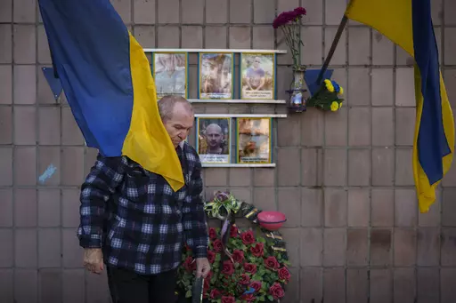 Oleksandr Turovskyi, father of Sviatoslav Turovskyi, in the top right picture, one of the men killed by Russian forces near the building on Yablunska street, leaves after bringing fresh flowers to the place where his son's body was abandoned, in Bucha, Ukraine, Tuesday, March 26, 2024. Days after Russian forces withdrew from the area in late March, in the dramatic first weeks of the full-scale invasion, a photo taken by AP Photographer Vadim Ghirda revealed what happened to the eight men. (AP Ph