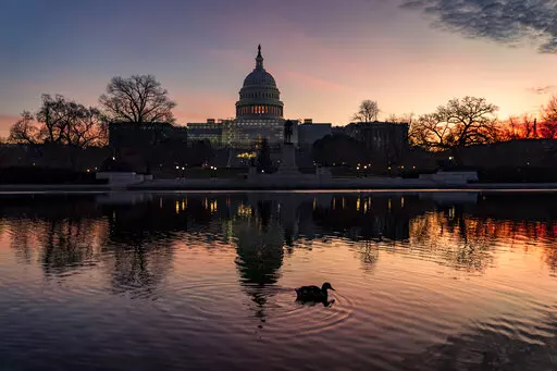 The sun rises behind the Capitol in Washington, early Wednesday, Dec. 14, 2022. Congressional leaders have unveiled a $1.7 trillion spending package early Tuesday, Dec. 20, 2022, that includes another large round of aid to Ukraine, a nearly 10% boost in defense spending and roughly $40 billon to assist communities across the country recovering from drought, hurricanes and other natural disasters. (AP Photo/J. Scott Applewhite, File)