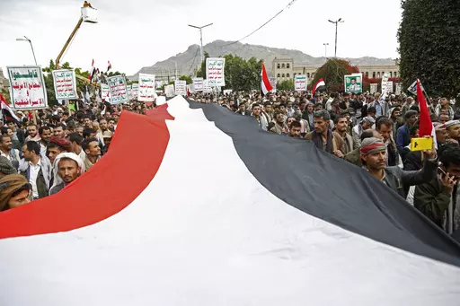 Houthi supporters chant slogans holding signs reading "Death to America, Death to Israel", as they attend a rally marking eight years for a Saudi-led coalition, Friday, March 26, 2023, in Sanaa, Yemen. For years, the Houthi rebels controlling northern Yemen have chanted slogans at their mass rallies calling for the destruction of Israel. But they never joined any conflict beyond the confines of their own country’s civil war or nearby in the Arabian Peninsula. The Iranian-backed Shiite Muslim f