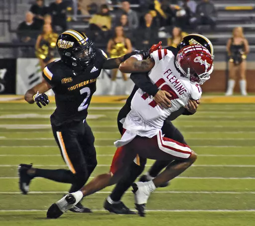 Southern Mississippi defensive back Camron Harrell (29) makes a tackle against Louisiana Lafayette wide receiver Dontae Fleming (17) as Eric Scott Jr. (2) comes into assist during an NCAA college football game, Thursday, Oct. 27, 2022 at M.M. Roberts Stadium in Hattiesburg, Miss. (Hunter Dawkins/The Gazebo Gazette via AP)