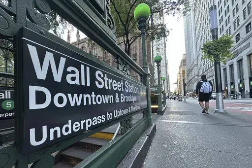 People pass the entrance for the Wall Street subway station on Sept. 2, 2024, in New York. (AP Photo/Peter Morgan, File)