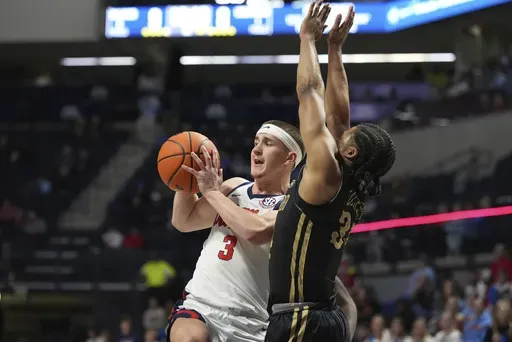 Mississippi guard Sean Pedulla (3) passes off while defended by Lindenwood guard Clayton Jackson (34) during the first half of an NCAA college basketball game, Saturday, Dec. 7, 2024, in Oxford, Miss. (AP Photo/Rogelio V. Solis)