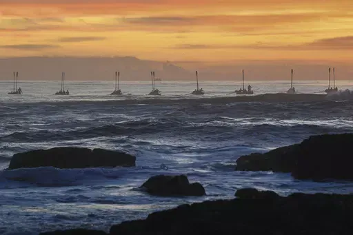 Surf boats perform during the Anzac Day dawn service at Elephant Rock in Currumbin on the Gold Coast, Australia, Thursday April 25, 2024. (Jono Searle/AAP Image/via AP)