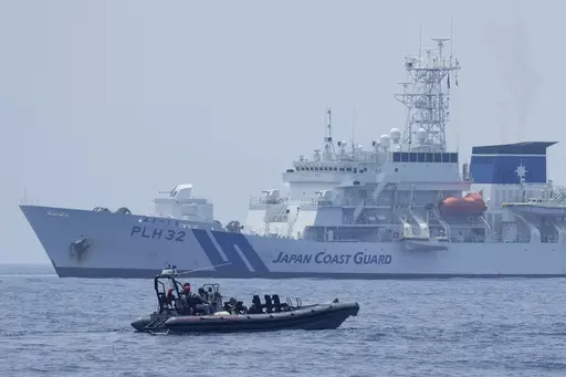 A Philippine Coast Guard rigid hull inflatable boat passes by the Japanese Coast Guard Akitsushima (PLH-32) during a trilateral Coast Guard drill of the U.S., Japan and Philippines, near the waters of the disputed South China See in Bataan province, Philippines, Tuesday, June 6, 2023. The United States, Japan and Australia are planning a joint navy drill in the South China Sea off the western Philippines this week to underscore their commitment to the rule of law in the region after a recent sho