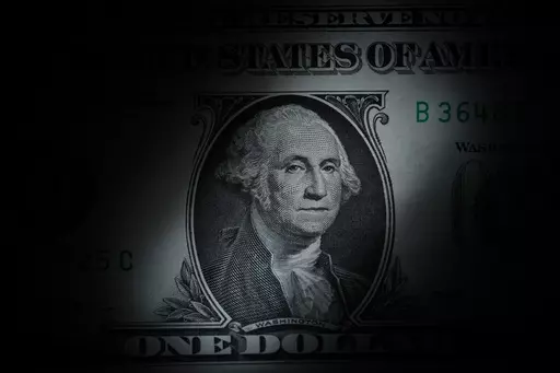 The likeness of George Washington is seen on a U.S. one dollar bill, Monday, March 13, 2023, in Marple Township, Pa. If you’ve sat your kids down to discuss Roth IRAs and compound interest, you might have been going about things the wrong way. Investing can seem dry and unapproachable, especially for kids, but the concept is amazing. (AP Photo/Matt Slocum, File)