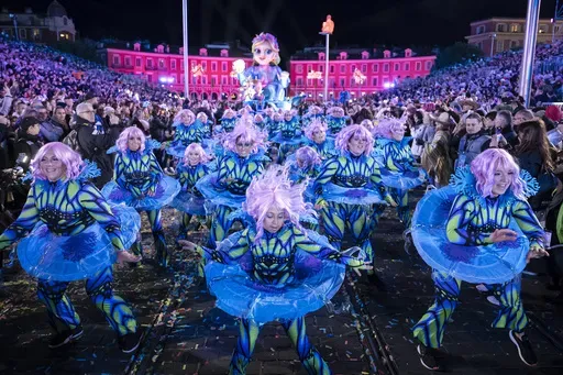 Performers dance during a parade through Place Massena during the opening ceremony of the 152nd edition of the Nice Carnival in Nice, southern France, Saturday, Feb. 15, 2025. (AP Photo/Lewis Joly)