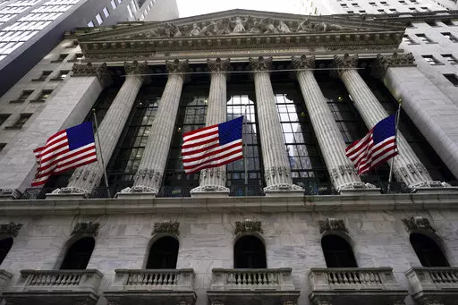 American flags fly outside the New York Stock exchange, Friday, Jan. 14, 2022, in the Financial District in New York. Stocks are off to a weak start on Wall Street, Thursday, Feb. 17, chipping away at the weekly gains for major indexes.  (AP Photo/Mary Altaffer, File)