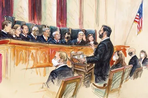This artist sketch depicts Marc Hearron, petitioner for Whole Woman's Health, standing while speaking to the Supreme Court, Monday, Nov. 1, 2021, in Washington. Seated to Hearron's left is Judd Stone II, Texas Solicitor General. Justices seated from left are Associate Justice Brett Kavanaugh, Associate Justice Elena Kagan, Associate Justice Samuel Alito, Associate Justice Clarence Thomas, Chief Justice John Roberts, Associate Justice Stephen Breyer, Associate Justice Sonia Sotomayor, Associated 