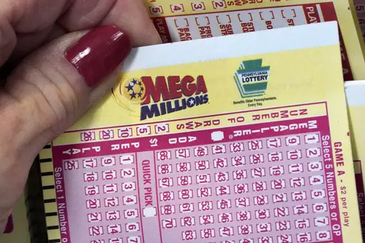 A Mega Millions wagering slip is held in Cranberry Township, Pa., Jan. 12, 2023. The Mega Millions jackpot has grown again, to at least an estimated $640 million, after there was no winner Friday night, July 14. (AP Photo/Gene J. Puskar, File)