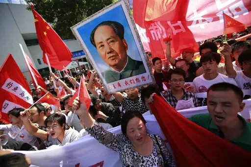 Anti-Japan protesters on disputed islands march near the Japanese Consulate General in Shanghai, China, on Sept. 16, 2012. Japan and China on Thursday, Sept. 29, 2022, mark the 50th anniversary of the 1972 normalization of their ties, but there isn't much of a celebratory mood. (AP Photo/Eugene Hoshiko, File)
