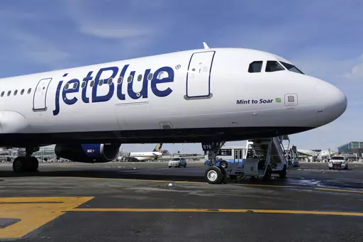 A JetBlue airplane is shown at John F. Kennedy International Airport in New York, March 16, 2017. A federal judge is siding with the Biden administration and blocking JetBlue Airways from buying Spirit Airlines, saying the $3.8 billion deal would reduce competition. The Justice Department sued to block the merger, saying it would drive up fares by eliminating Spirit, the nation’s biggest low-cost airline. (AP Photo/Seth Wenig, File)