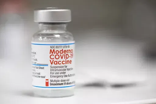 A vial of the Moderna COVID-19 vaccine is displayed on a counter at a pharmacy in Portland, Ore. on Dec. 27, 2021. U.S. health authorities are facing a critical decision: whether to offer COVID-19 booster shots this fall that better match the omicron variant even though the coronavirus already has spawned still more mutants. Moderna and Pfizer are testing updated booster candidates, and advisers to the U.S. Food and Drug Administration will debate Tuesday, June 28, 2022, if it’s time for a swi