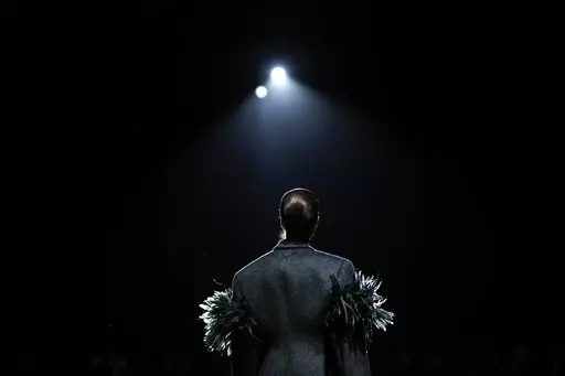 A model wears a creation as part of the Prada Fall/Winter 2022-2023 fashion collection, unveiled during the Fashion Week in Milan, Italy, Thursday, Feb. 24, 2022. (AP Photo/Luca Bruno)