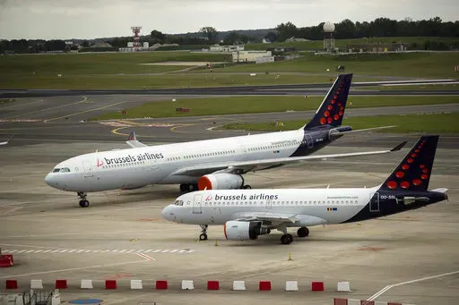 In this Tuesday, May 12, 2020 file photo, planes from Brussels Airlines on the tarmac at Brussels Airport in Brussels Tuesday, May 12, 2020. The European Union's airspace is filling up again with near-empty flights in pandemic times that even airlines admit serve no commercial purpose except securing valuable slots in some of the world's biggest airports. (AP Photo/Francisco Seco, File)