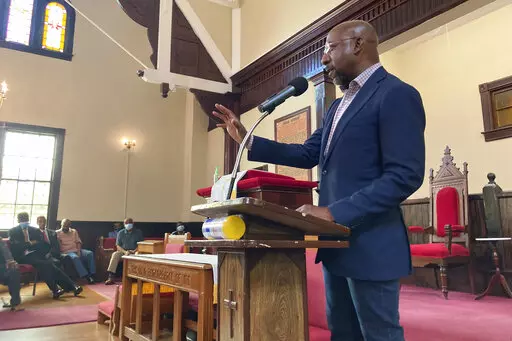 Sen. Raphael Warnock, D-Ga., who is the pastor of Ebenezer Baptist Church in Atlanta, campaigns at a church by the same name in Eatonton, Ga., on Aug. 18, 2022. Warnock and his Republican challenger Herschel Walker both tout faith in their public lives but they offer vastly different visions and applications of Christianity. Warnock hails from the Black church tradition of social action. Walker, who is also Black, aligns more with the cultural conservatism of white evangelicals who have shaped t