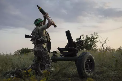 A Ukrainian serviceman of the 3rd Assault Brigade fires a 122mm mortar towards Russian positions at the front line, near Bakhmut, Donetsk region, Ukraine, Sunday, July 2, 2023. Employees from a Ukrainian arms firm conspired with defense ministry officials to embezzle almost $40 million earmarked to buy 100,000 mortar shells for the war with Russia, Ukraine's security service reported. The SBU said late Saturday, Jan. 27, 2024 that five people have been charged and the money has been recovered. (