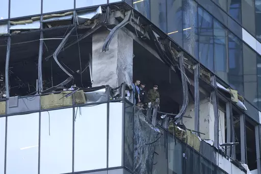Investigators examine a damaged skyscraper in the "Moscow City" business district after a reported drone attack in Moscow, Russia, early Sunday, July 30, 2023. (AP Photo)