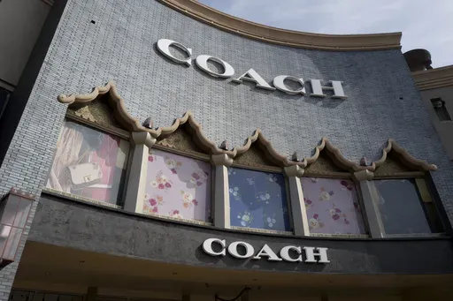 A chain of the Coach brand, owned by parent company Tapestry, is seen, May 3, 2019, at the Citadel Outlets in Commerce, Calif. (AP Photo/Richard Vogel, File)