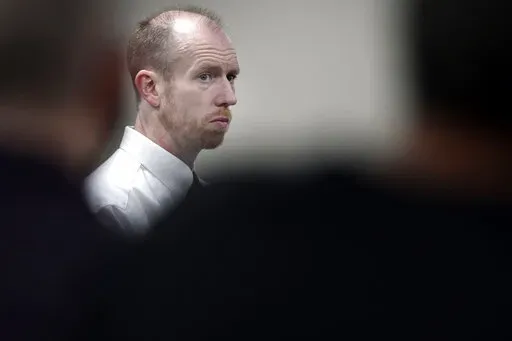 FILE - Chad Isaak, of Washburn, N.D., appears during the third day of his murder trial at the Morton County Courthouse in Mandan, N.D., on Aug. 4, 2021. Isaak is scheduled for sentencing Tuesday, Dec. 28, 2021, in the stabbing and shooting deaths of four people at a North Dakota property management firm last year. Isaak is facing life in prison without parole. A jury in August found him guilty in the grisly deaths of RJR Maintenance and Management co-owner Robert Fakler and three employees. (Mik