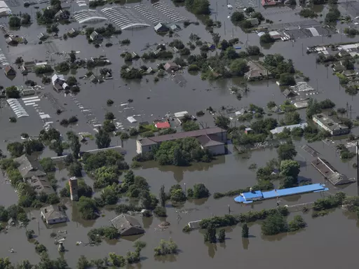 Houses are seen underwater in the flooded village of Dnipryany, in Russian-occupied Ukraine, Wednesday, June 7, 2023, after the collapse of Kakhovka Dam. Thousands of people are believed to be trapped by floodwaters spread across a swath of Ukraine after a catastrophic dam collapse. (AP Photo, File)