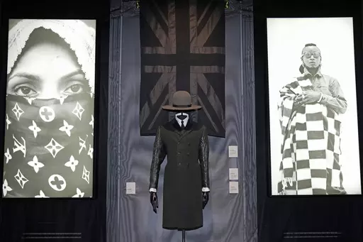 A black union jack shawl, Madhatter crown hat and Rudie coat designed by London-based art collective Art Comes First, are displayed during a preview of the exhibition titled "The Missing Thread: Untold Stories of Black British Fashion", at Somerset House, in London, Tuesday, Sept. 19, 2023. A new exhibition is opening in London to chart for the first time the contributions Black British culture made to U.K. fashion and design history and to celebrate Black designers who have not received public 