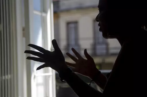 Diana gives an interview in Havana, Cuba, Thursday, Nov. 3, 2022. Diana said she endured screams, insults and confinement for seven years before she ended a seven year relationship with her boyfriend, but that she did not reach out to any institutions or programs that handled cases of violence against women because she had no faith that they could protect her. Diana asked that her last name not be published because she was afraid for her safety.  (AP Photo/Ismael Francisco)