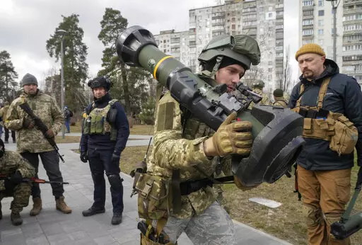 A Ukrainian Territorial Defence Forces member holds an NLAW anti-tank weapon, in the outskirts of Kyiv, Ukraine, March 9, 2022. (AP Photo/Efrem Lukatsky, File)