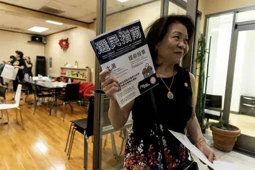 Vida Lin, president and founder of the Asian Community Development Council, holds a voter information booklet her group translated into Chinese during the annual Dragon Boat Festival in Las Vegas, Wednesday, June 5, 2024. (Christopher Lomahquahu/News21 via AP)