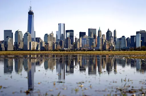 New York's Lower Manhattan skyline, including the One World Trade Center, left, is reflected in water on April 6, 2013, as seen from Liberty State Park in Jersey City, N.J. Eight of the 10 largest cities in the U.S. lost population during the first year of the pandemic, with only Phoenix and San Antonio gaining new residents from 2020 to 2021, according to new estimates released, Thursday, May 26, 2022, by the U.S. Census Bureau. (AP Photo/Mel Evans, File)