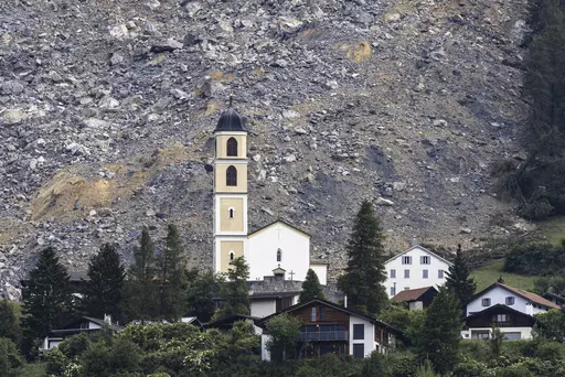 General view of part of the village of Brienz-Brinzauls below the rockfall "Brienzer Rutsch", in Switzerland, Friday, June 16, 2023. On Thursday night, a large part of the rock masses fell towards the village. The rock masses just missed the village and left behind a meter-high deposit on the main road near the school building. No one was injured since the village was evacuated on May 12. (Michael Buholzer/Keystone via AP)