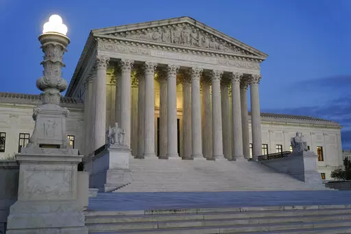 Light illuminates part of the Supreme Court building at dusk on Capitol Hill in Washington, Nov. 16, 2022. The Supreme Court has agreed to hear an appeal arising from a murder-for-hire ordered by the onetime leader of a violent international crime ring. The justices said Tuesday they will review the case of Adam Samia, who is serving a life sentence for killing a real estate broker in the Philippines. (AP Photo/Patrick Semansky, File)