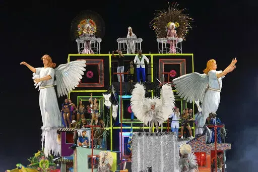 Dancers from the Unidos da Vila Maria samba school perform on a float during a carnival parade in Sao Paulo, Brazil, Saturday, April 23, 2022. (AP Photo/Andre Penner)