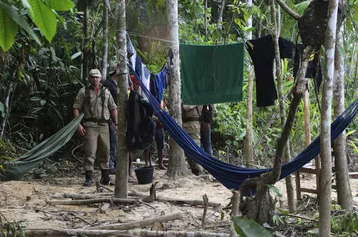 Firefighters arrive at a camp set up by Indigenous people to search for Indigenous expert Bruno Pereira and freelance British journalist Dom Phillips in Atalaia do Norte, Amazonas state, Brazil, Tuesday, June 14, 2022. The search for Pereira and Phillips, who disappeared in a remote area of Brazil's Amazon continues following the discovery of a backpack, laptop and other personal belongings submerged in a river. (AP Photo/Edmar Barros)