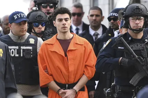 Luigi Mangione, a suspect in the fatal shooting of UnitedHealthcare CEO Brian Thompson, is escorted by police, Thursday, Dec. 19, 2024, in New York. (AP Photo/Pamela Smith)