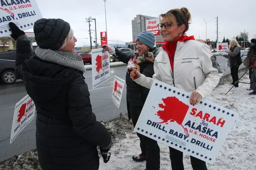 Former Alaska Gov. Sarah Palin, a Republican candidate for Alaska's sole seat in the U.S. House, meets with supporters waving her signs on Nov. 8, 2022, on a street corner in Anchorage, Alaska. Palin re-emerged in Alaska politics over a decade after resigning as governor with hopes of winning the state's U.S. House seat. But she struggled to catch fire with voters and ran what critics saw as a lackluster campaign against a breakout Democrat who pitched herself as a regular Alaskan and a Republic