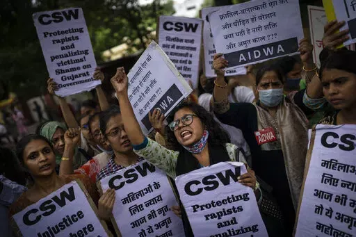 Activists shout slogans against the remission of sentence by the government to convicts of a gang rape, in New Delhi, India, Thursday, Aug. 18, 2022. A Muslim woman who was gang raped while pregnant during India's devastating 2002 religious riots has appealed to the government to rescind its decision to free the 11 men who had been jailed for life for committing the crime, after they were released on suspended sentences. The 11 men, released on Monday when India celebrated 75 years of independen