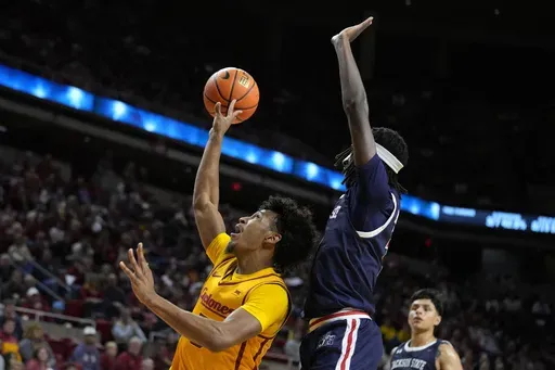 Iowa State guard Curtis Jones, left, is fouled by Jackson State guard Dorian McMillian, front right, while driving to the basket during the first half of an NCAA college basketball game Sunday, Dec. 8, 2024, in Ames, Iowa. (AP Photo/Charlie Neibergall)