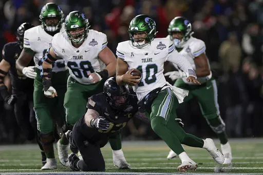 Tulane quarterback Darian Mensah (10) carries the ball against Army during the first quarter of the American Athletic Conference championship NCAA college football game Friday, Dec. 6, 2024, in West Point, N.Y. (AP Photo/Adam Hunger)