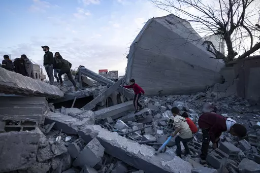Palestinians look at a mosque destroyed in an Israeli strike in Rafah, Gaza Strip, Wednesday, Jan. 24, 2024. Efforts to reach a new cease-fire between Israel and Hamas appear to be gaining steam. Any deal would have to include a pause in fighting, an exchange of hostages held by Hamas for Palestinian prisoners held by Israel and large quantities of desperately needed humanitarian assistance for the war-battered Gaza Strip. But finding a formula acceptable to both sides has been elusive. The gaps