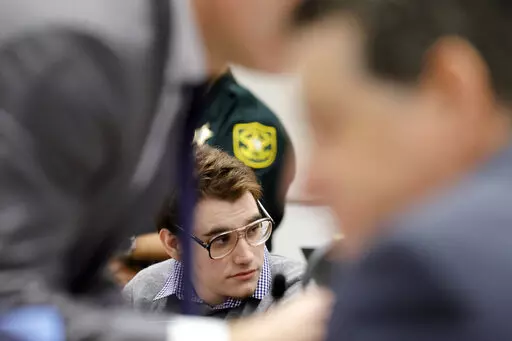 Marjory Stoneman Douglas High School shooter Nikolas Cruz is shown at the defense table during the penalty phase of Cruz's trial at the Broward County Courthouse in Fort Lauderdale, Fla., on Monday, Sept. 12, 2022. Cruz pleaded guilty to murdering 17 students and staff members in 2018 at Parkland's high school. The trial is only to determine if the 23-year-old is sentenced to death or life without parole. (Amy Beth Bennett/South Florida Sun-Sentinel via AP, Pool)