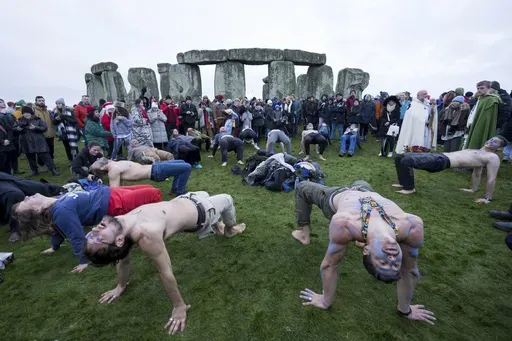 People tale part in the winter Solstice celebrations at Stonehenge, England, Saturday, Dec. 21, 2024. (AP Photo/Anthony Upton)