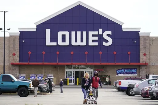 Shoppers walk in the lot of a Lowe's home improvement store in Philadelphia, Wednesday, Nov. 17, 2021. (AP Photo/Matt Rourke, File)